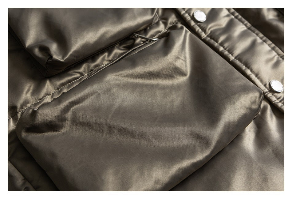 Close-up of a large patch pocket on a taupe jacket, with part of the snap-button front visible.
