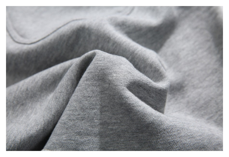 Close-up of heather gray shorts fabric gathered into soft folds.