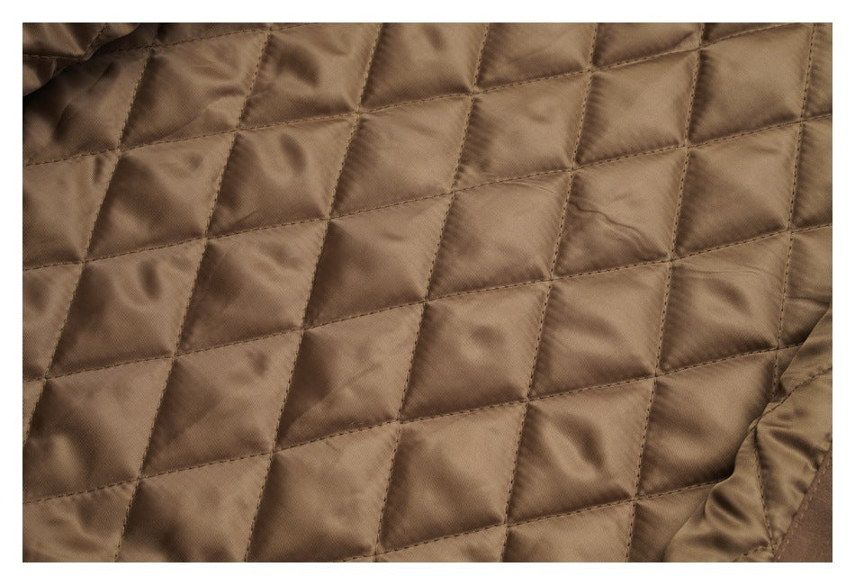Close-up of brown quilted jacket lining with rectangular stitched panels.
