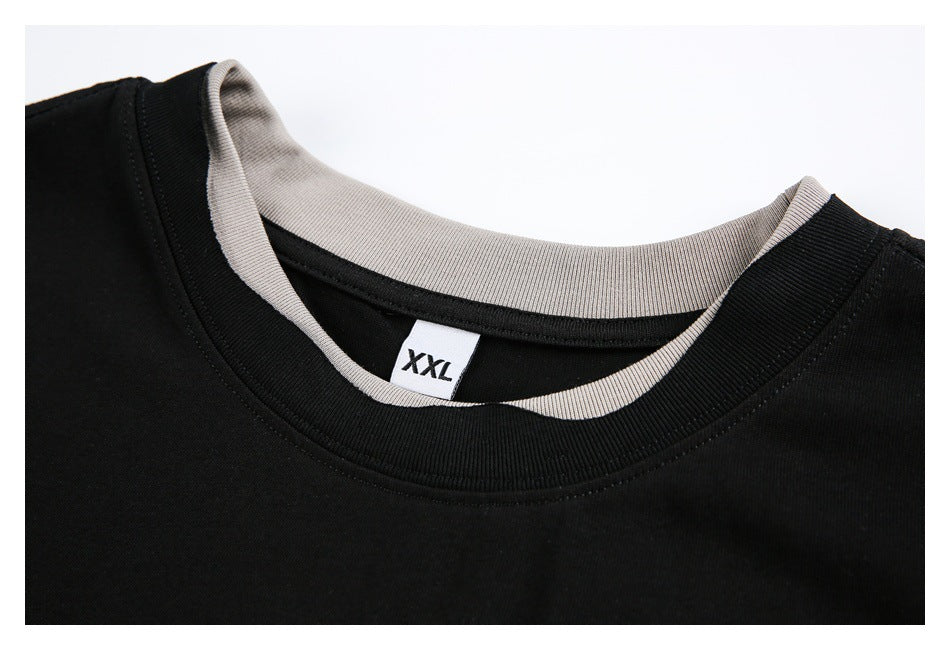 Close-up of the black T-shirt's layered gray and black collar and an XXL size label.