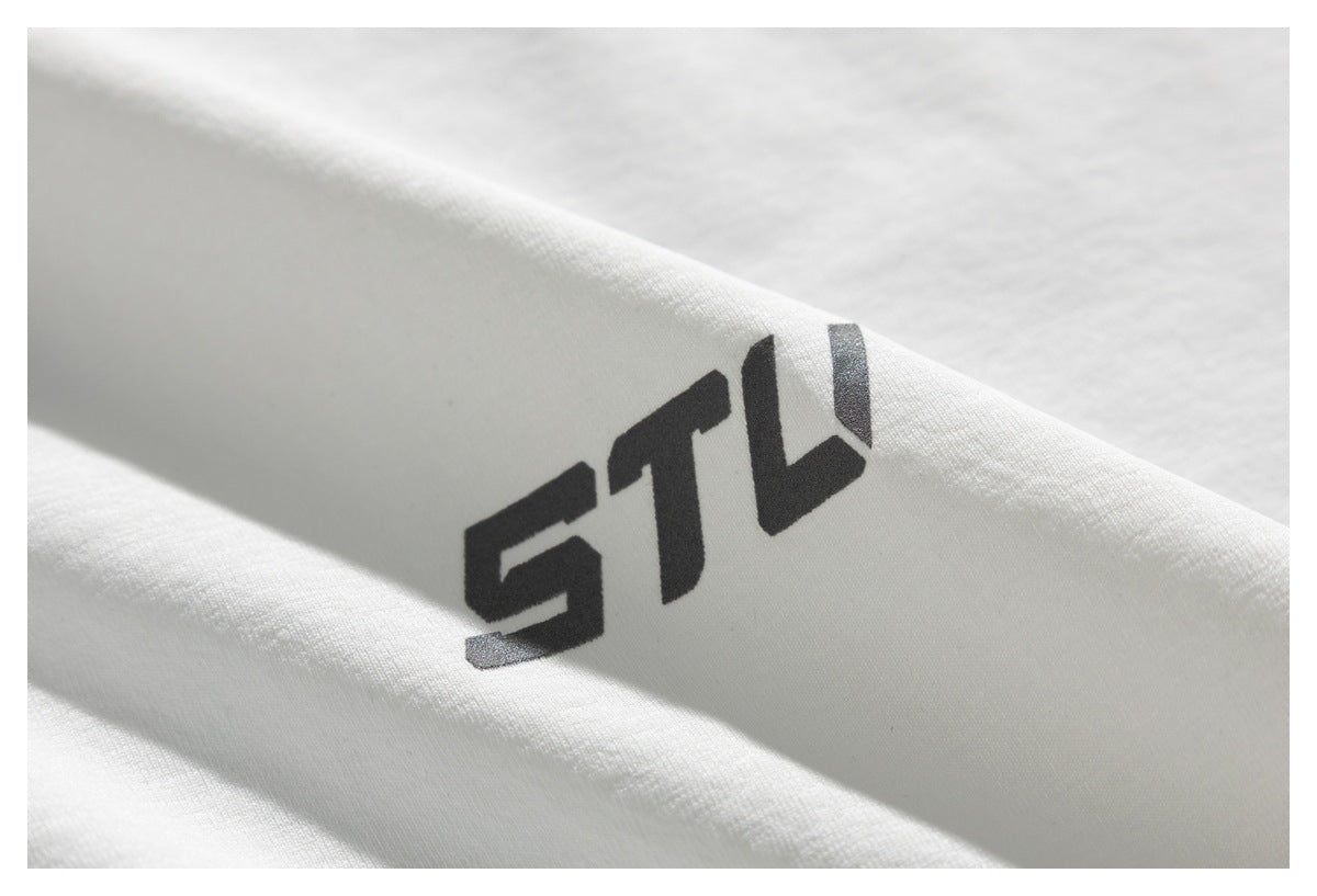 Close-up of bold black stylized lettering printed on white fabric.