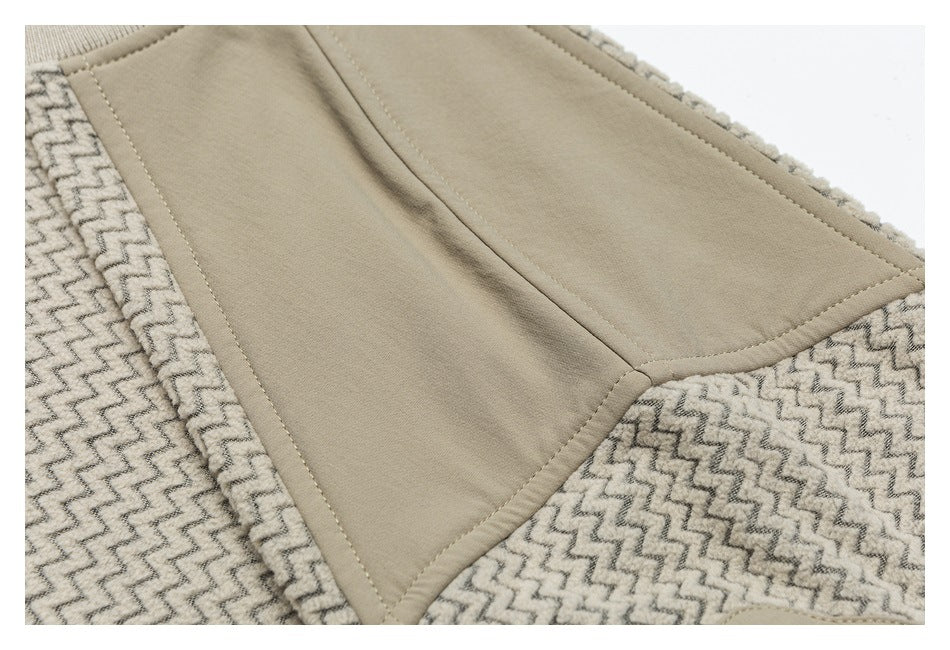 Close-up of a smooth taupe garment panel bordered by beige fabric with a dark zigzag pattern.