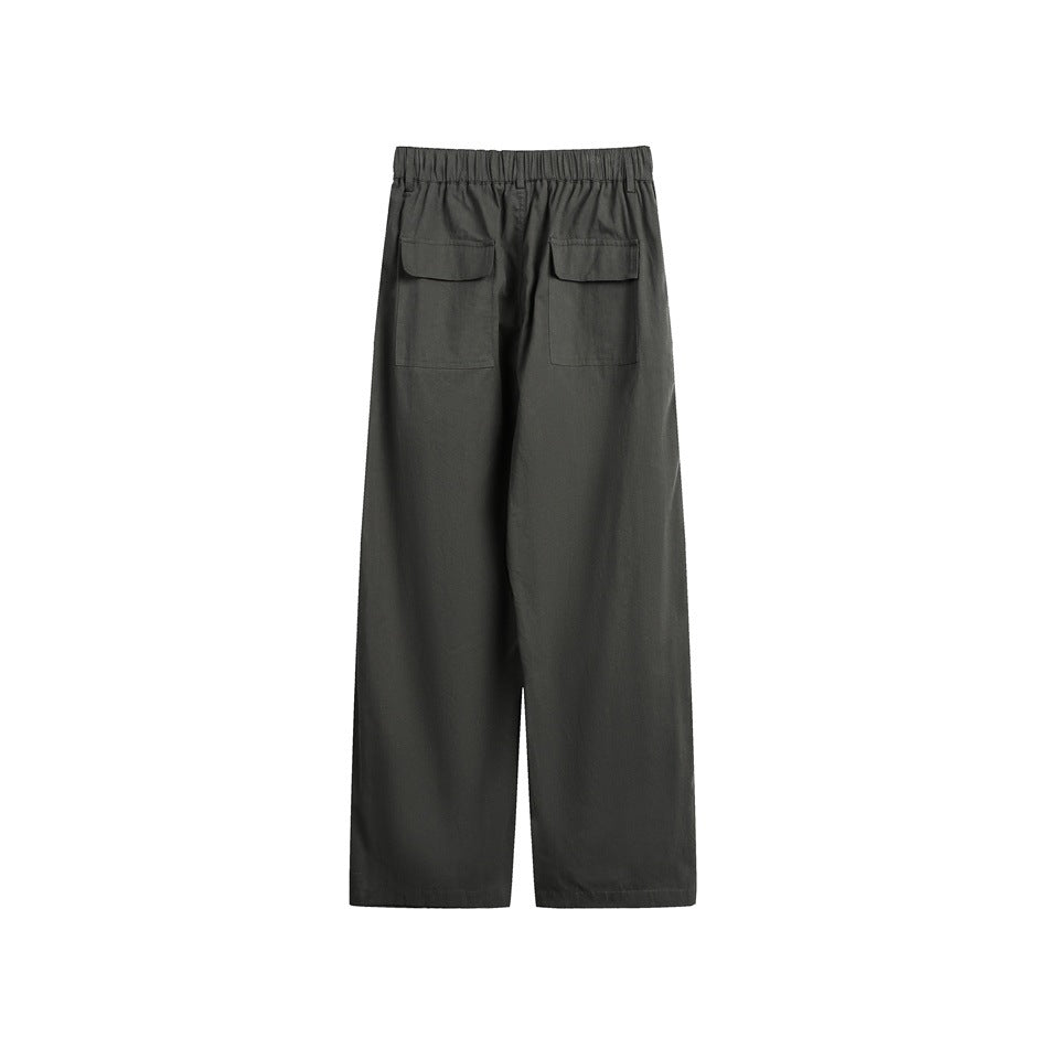 Back view of dark charcoal wide-leg trousers with an elastic waistband and two flap patch pockets.