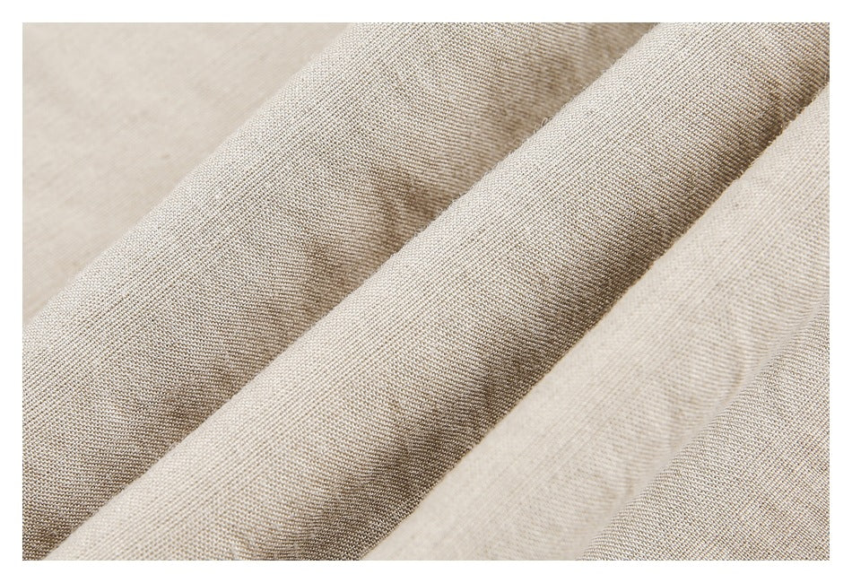 Extreme close-up of the beige trouser fabric and its woven texture.