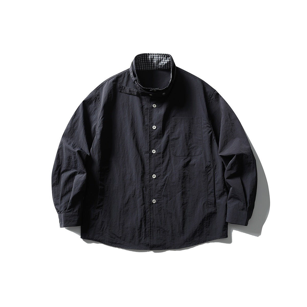 Navy button-front jacket flat lay with collar strap fastened, check inner collar and chest patch pocket