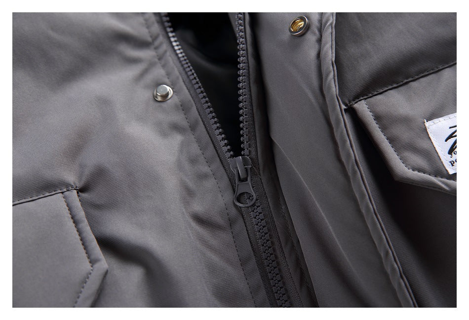 Close-up of the jacket's front zipper, snap fasteners, and pocket edge.