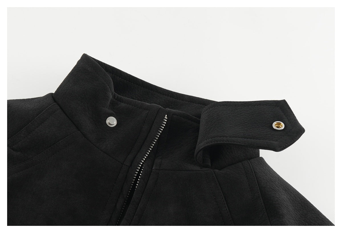 Close-up of a black jacket collar with an open zipper and snap-fastening collar tab.