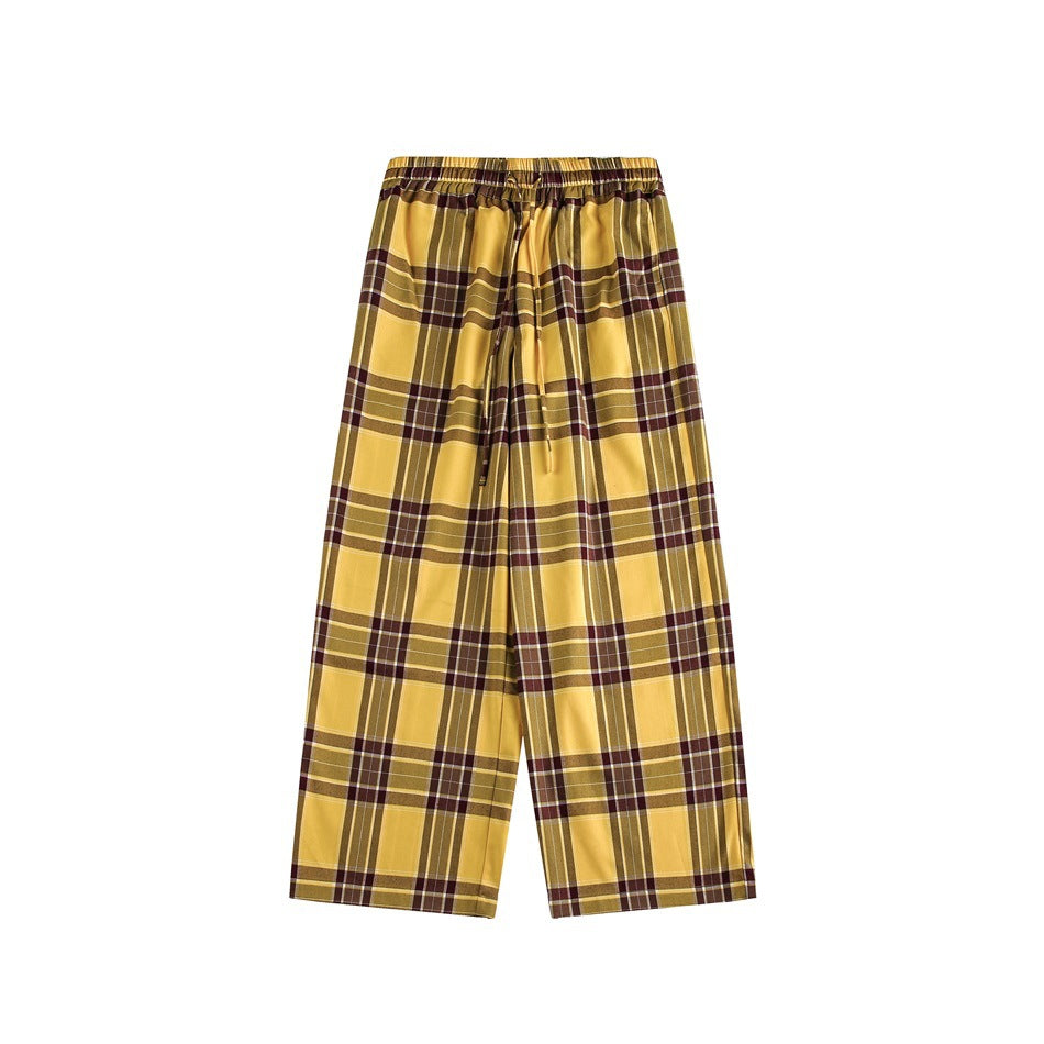 Flat view of yellow, brown and white plaid wide-leg pants with an elastic waistband and drawstring