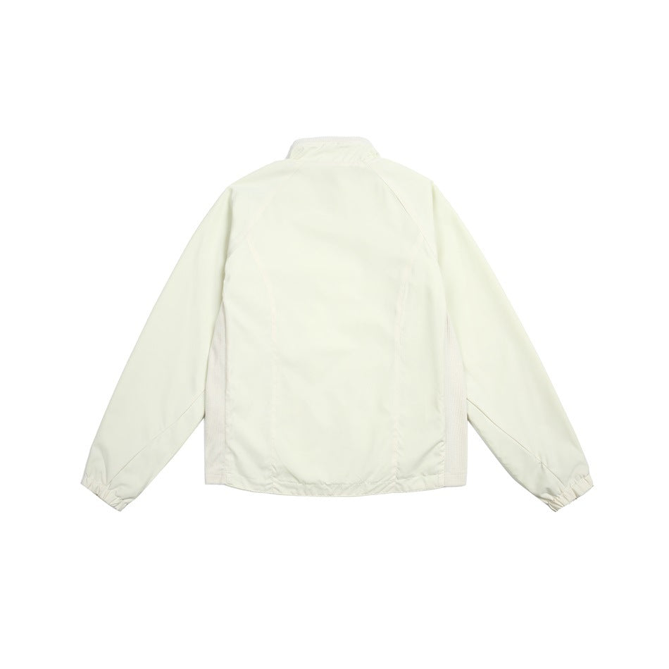 Back view of an off-white jacket with raglan sleeves, elastic cuffs, and light mesh side panels.