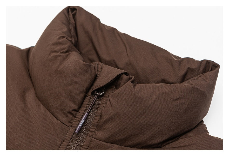 Close-up of the raised collar and zipper on a brown garment.