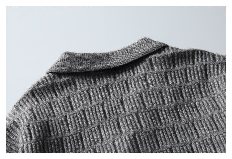 Close-up of the gray sweater's folded collar and raised ribbed knit pattern.