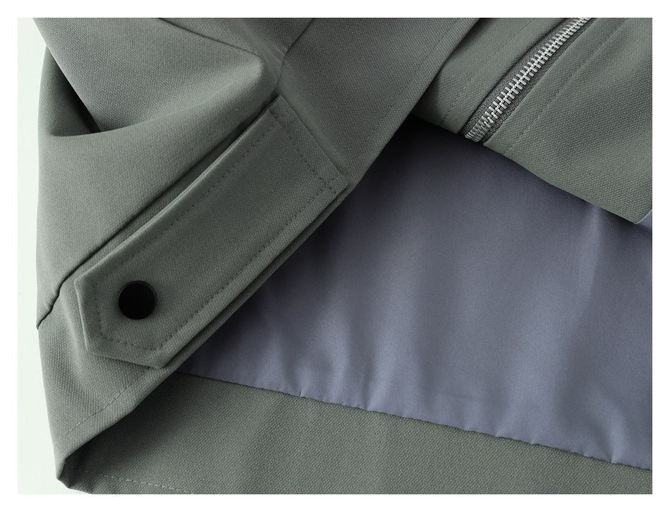 Close-up of the jacket interior, showing pale lining and a gray-green cuff with a black snap.