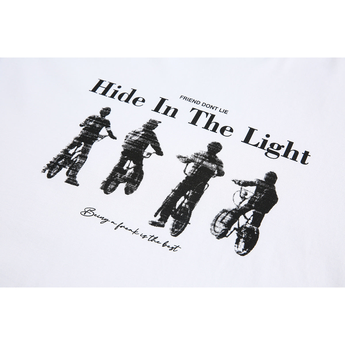 Black graphic on white fabric shows four cyclists with the words “Hide In The Light” and smaller English text.