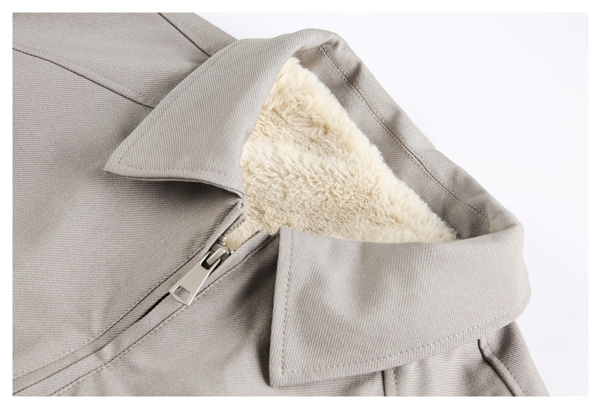 Close-up of a light gray jacket collar, plush cream lining, and metal zipper.