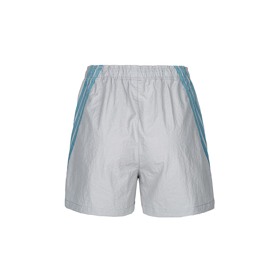 Gray woven shorts with an elastic waistband and blue diagonal stripes, seen from behind