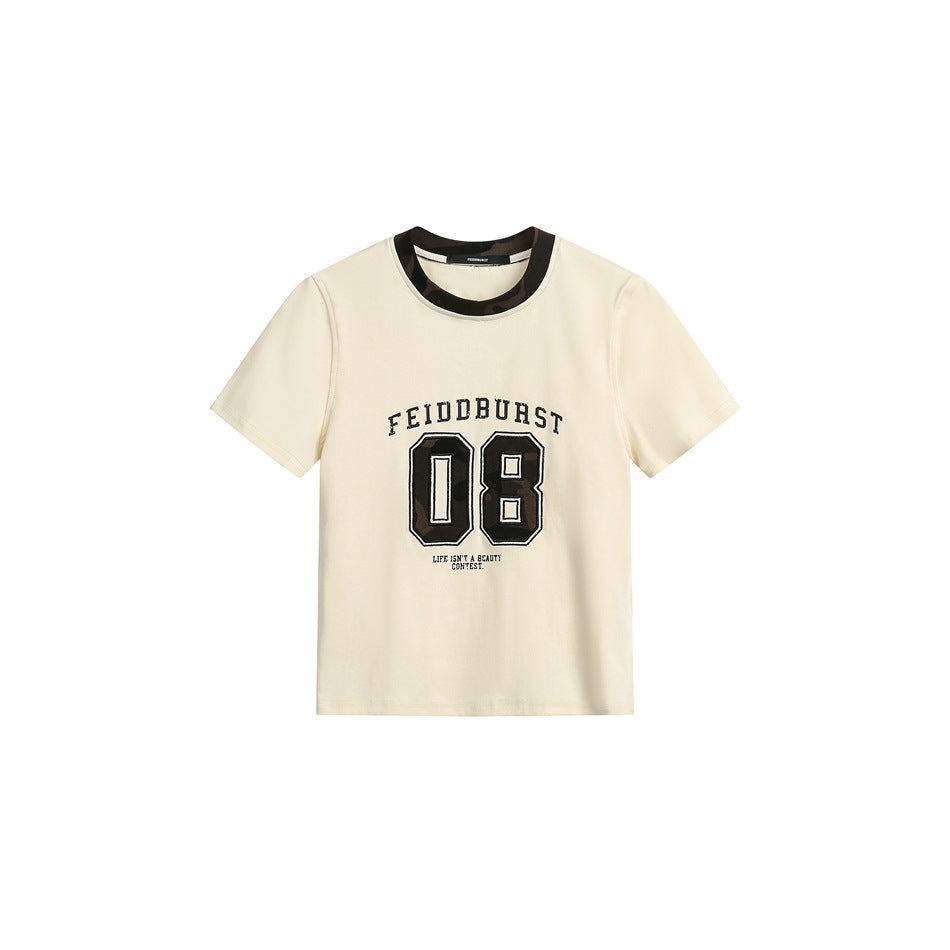 Beige short-sleeve cropped tee with camo neckband and black varsity 08 graphic, flat front view