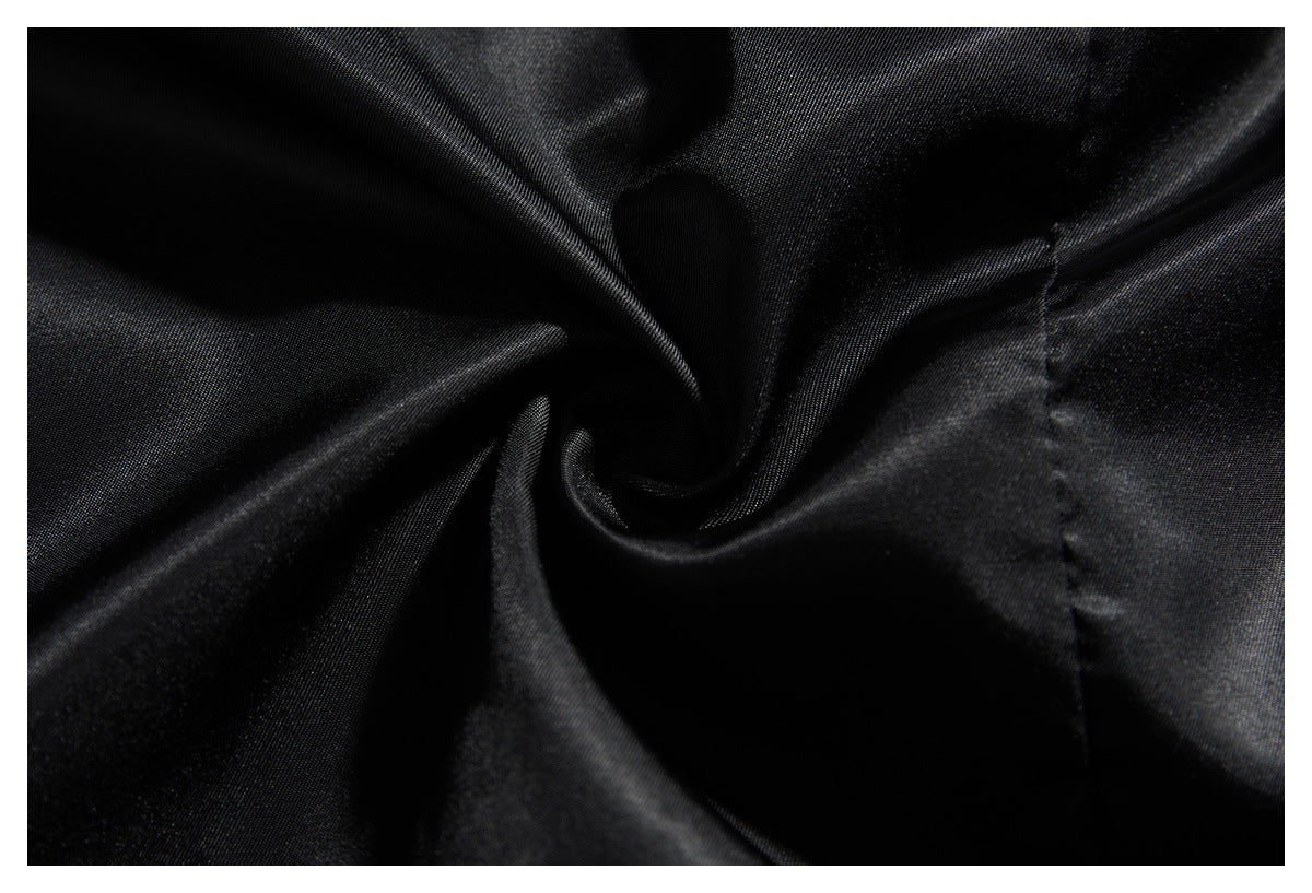 Close-up of the black jacket's smooth lining gathered into a spiral fold.