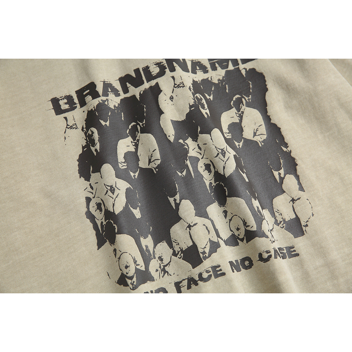 Angled close-up of the beige T-shirt’s black crowd graphic and distressed English lettering.