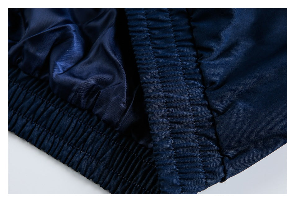 Close-up of dark navy garment fabric with gathered elastic stitching along the edge.
