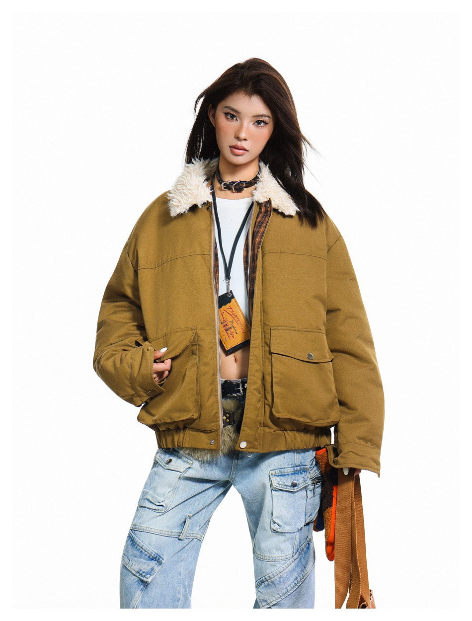 Model in an ochre-brown jacket with a cream faux-fur collar, plaid inner trim and large flap pockets.