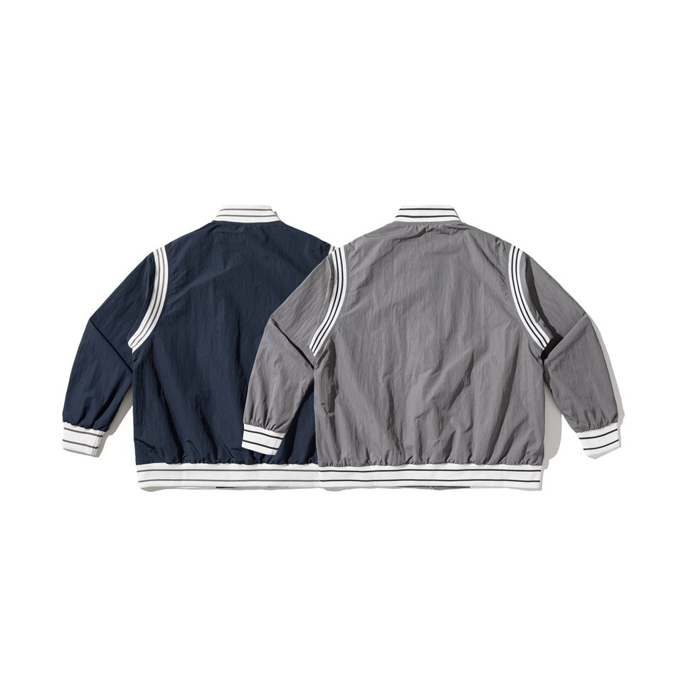 Back views of the same jacket in navy and gray, both with white striped trim.
