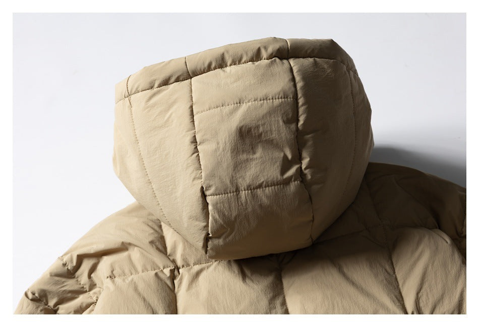 Close-up of the tan padded jacket's quilted hood and upper back.
