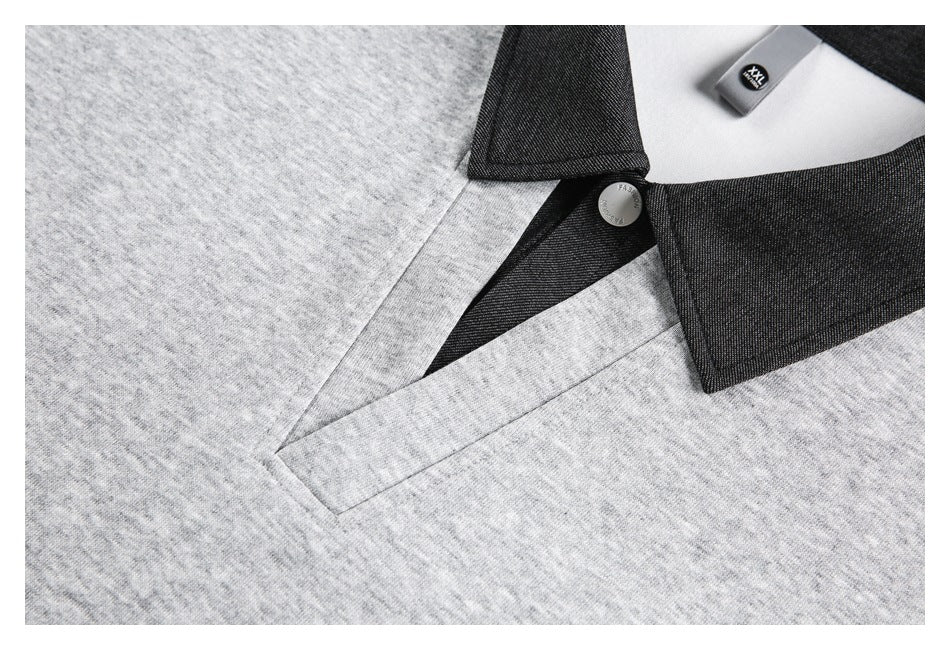 Close-up of the gray polo's dark collar, button, and stitched placket.