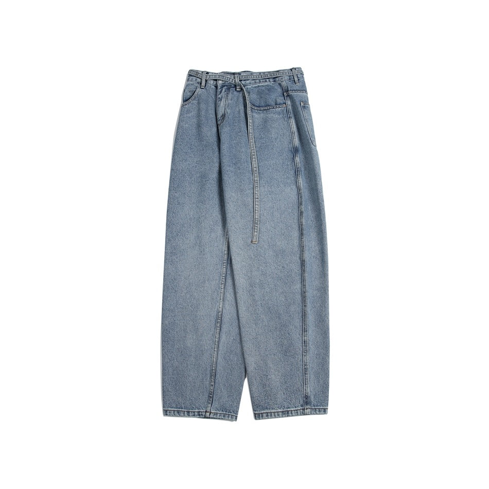 Angled front view of light-wash, wide-leg jeans showing the pockets, seams, and long matching belt.