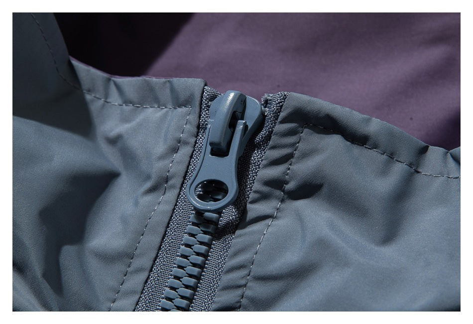Close-up of a large gray-blue zipper and stitching on a garment.