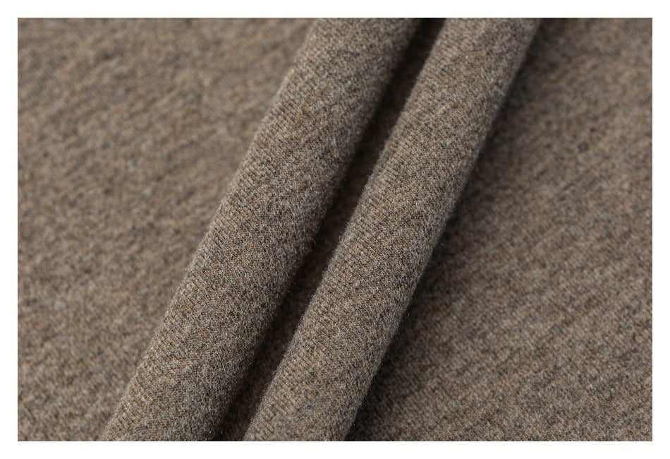 Close-up of heathered taupe-brown fabric draped into soft folds.