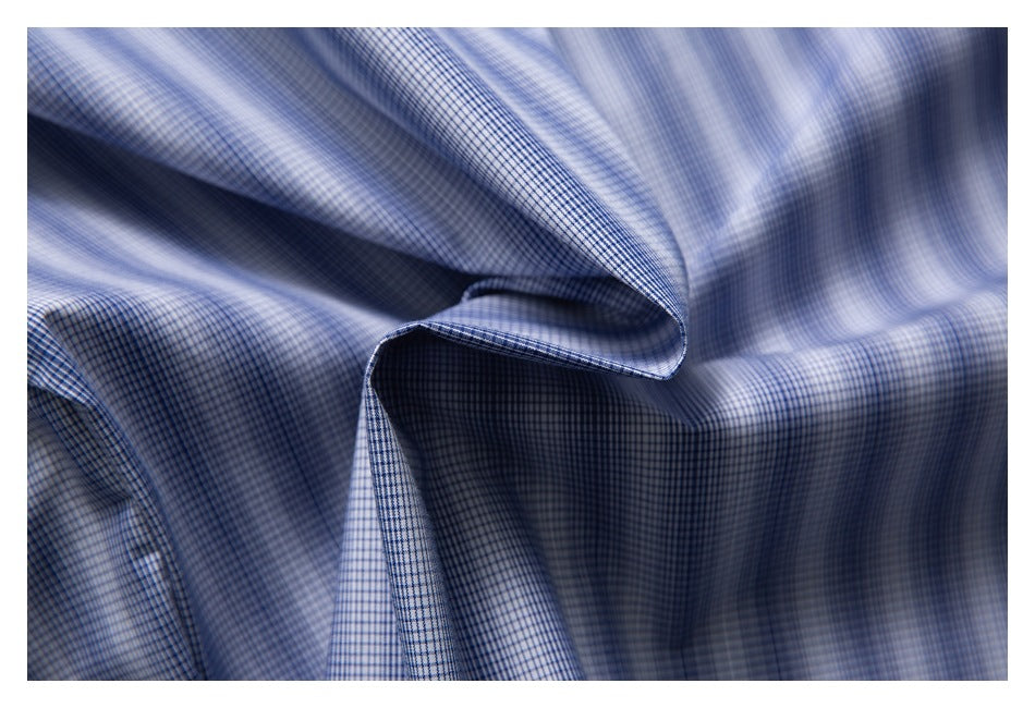 Close-up of blue-and-white checked shirt fabric draped in soft folds.