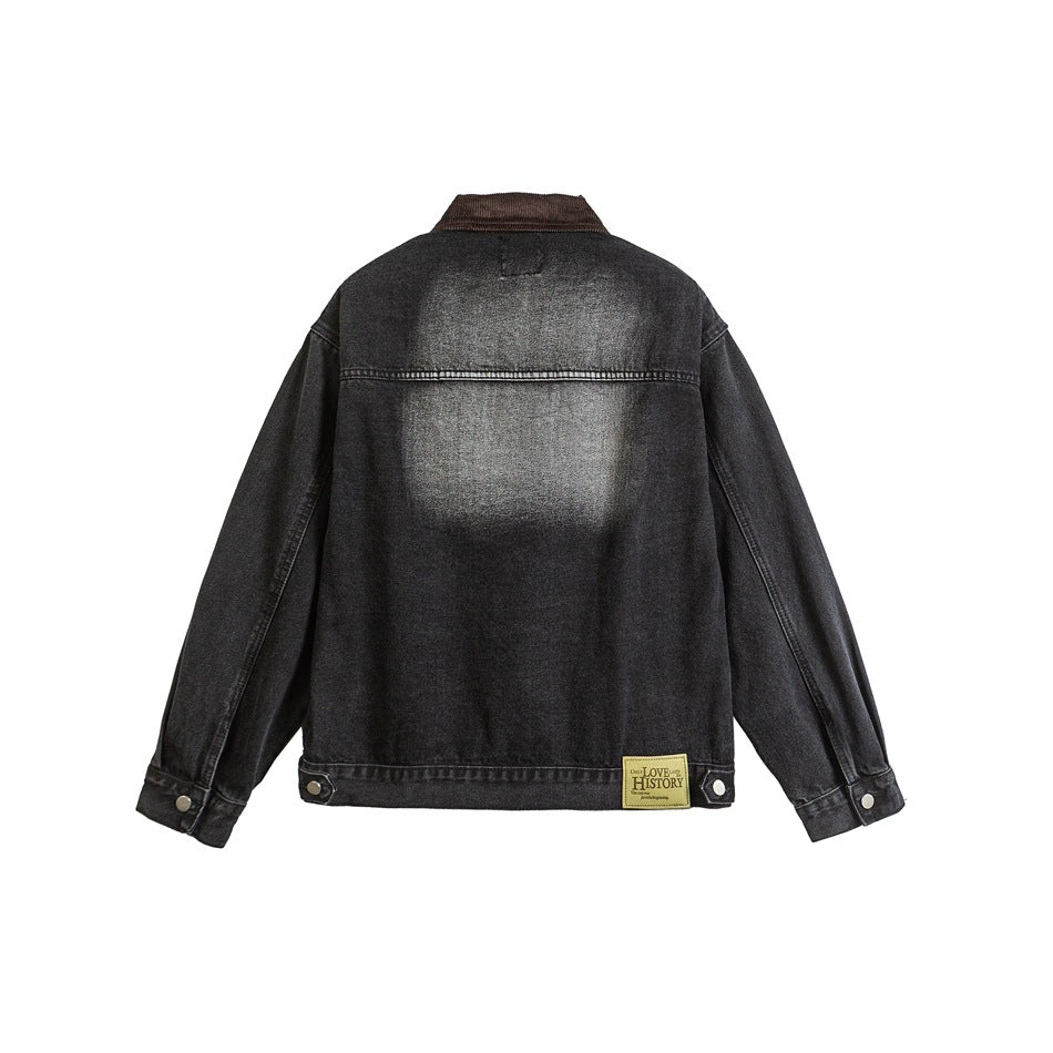 Back view of black washed denim jacket with brown collar, faded back panel, yoke seam and small hem patch