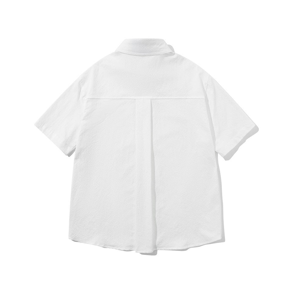 Back view of a white short-sleeve button-up shirt with a center pleat and yoke seam.