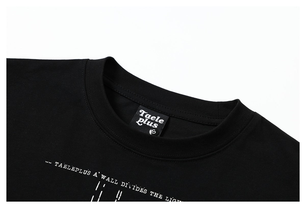 Close-up of a black T-shirt neckline, branded neck label, and partial white printed text.