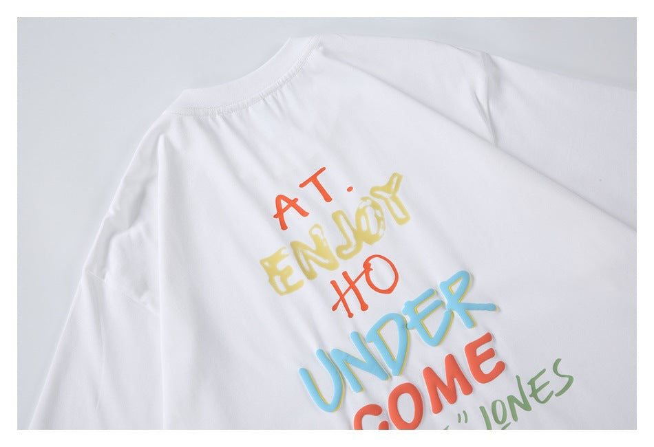 Close-up of a white shirt with colorful raised English lettering printed across the back.