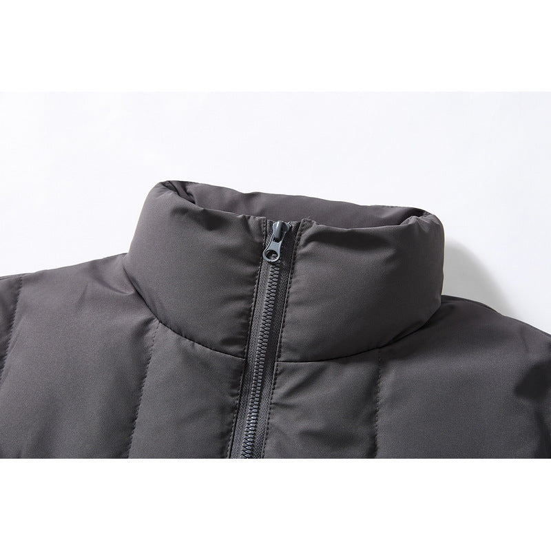 Close-up of a charcoal puffer jacket's tall stand collar and central front zipper.