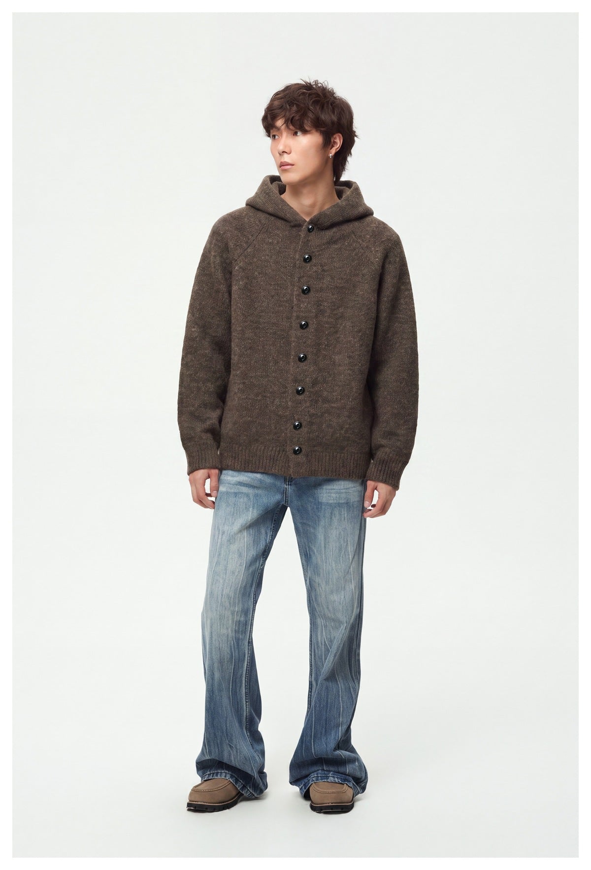 Full-length model wearing a brown hooded cardigan with black buttons and blue jeans.