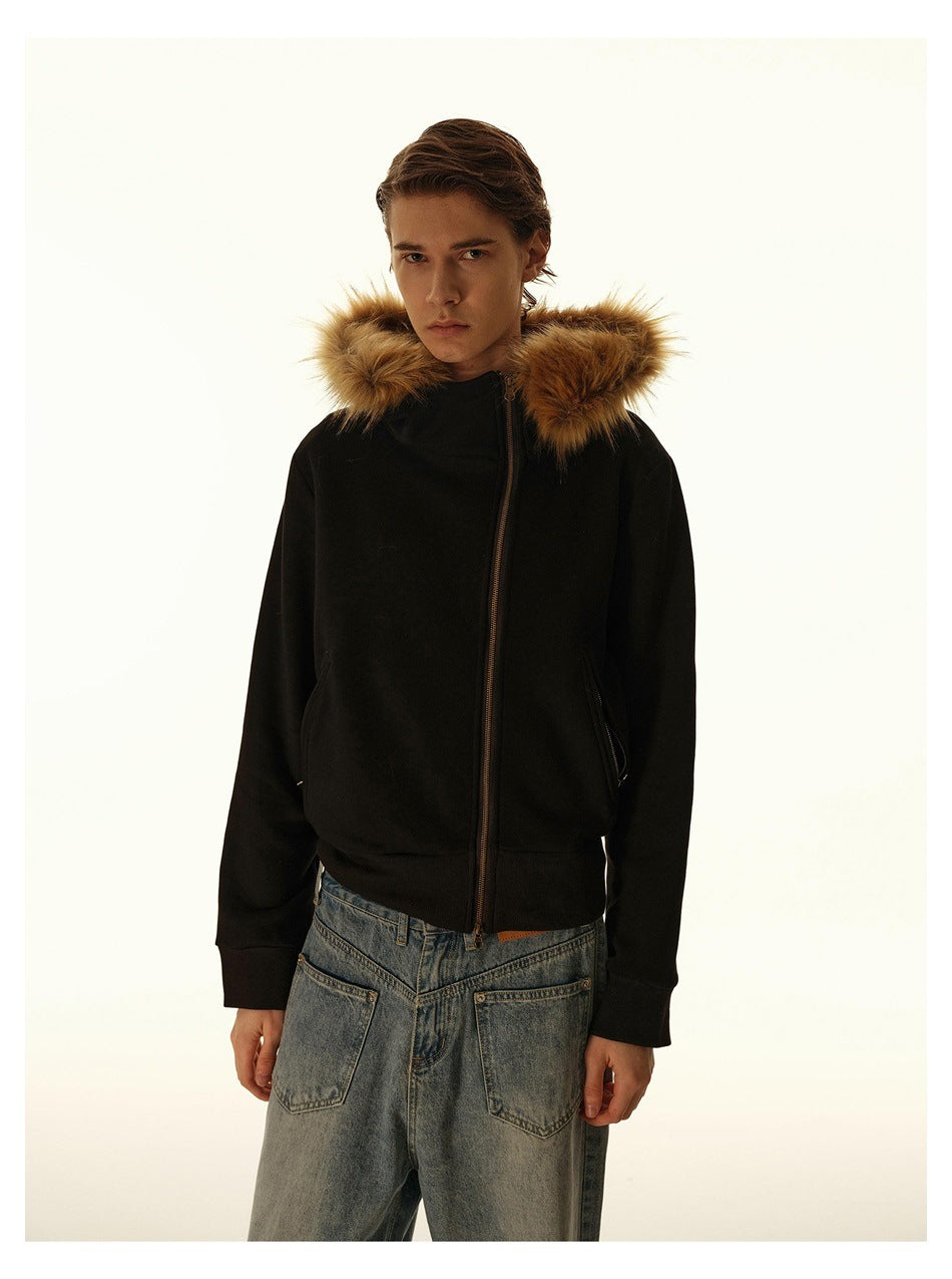 Man wearing a black zip-front jacket with a tan fur-trimmed hood and slanted front pockets.