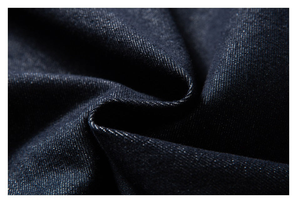 Macro view of dark indigo fabric gathered into soft folds.