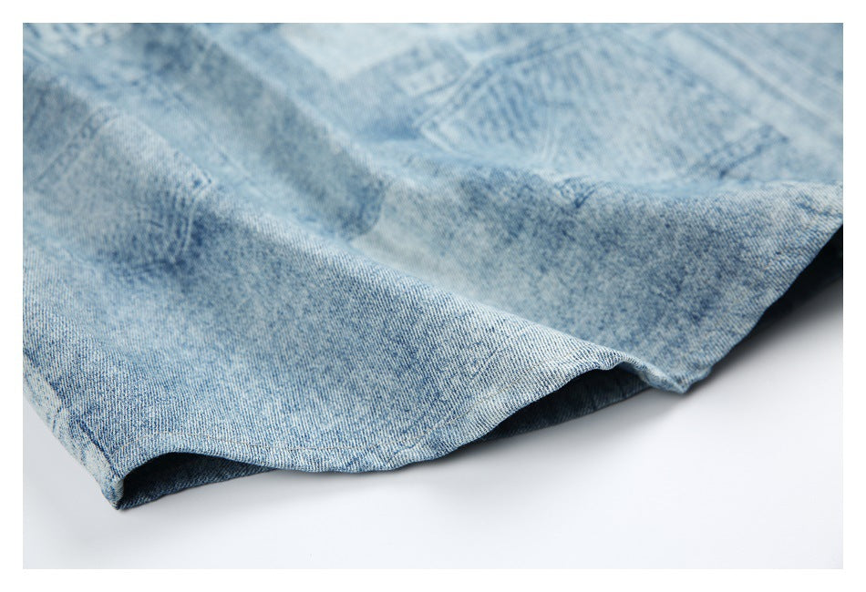 Close-up of a light blue mottled denim garment hem with visible stitching.