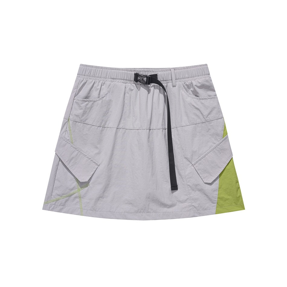 Light gray mini skirt with black buckle belt, flap pockets and green side panel on white background