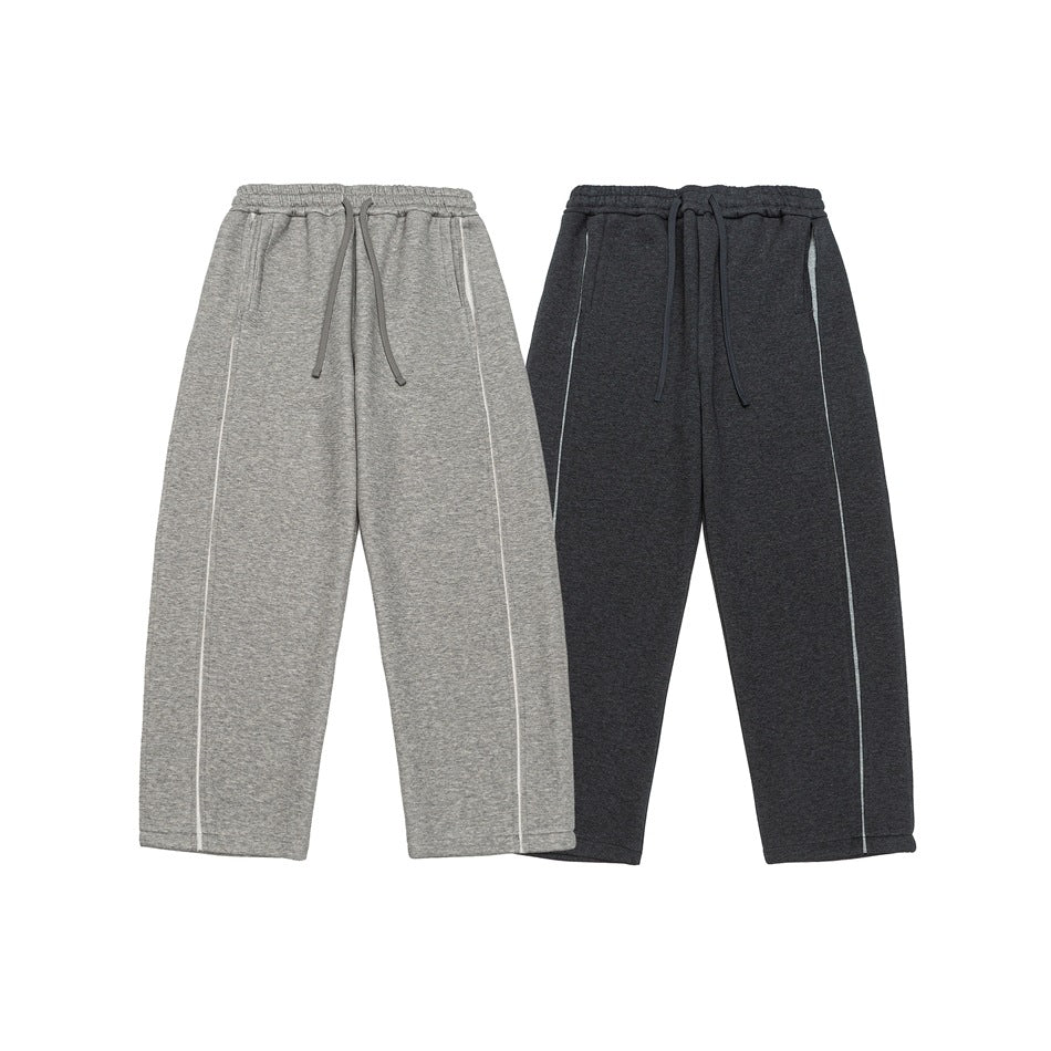 Two pairs of wide-leg drawstring pants displayed flat: light gray and charcoal, each with long side seams.
