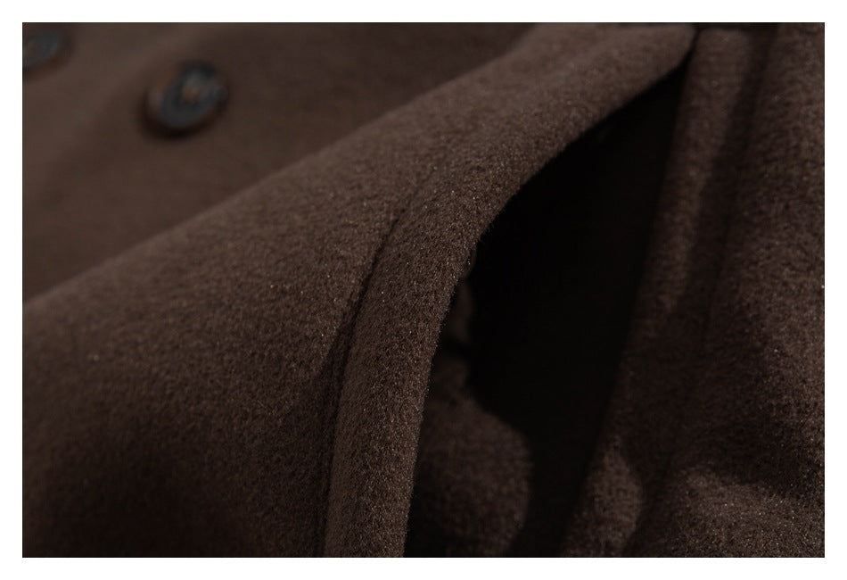 Extreme close-up of the brown coat's textured fabric and seam, with buttons blurred in the background.