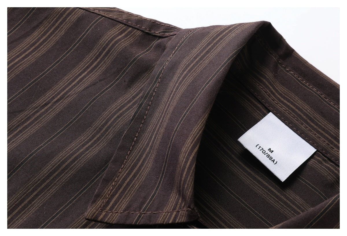 Close-up of the dark brown shirt's striped collar, neckline stitching, and white size M label.