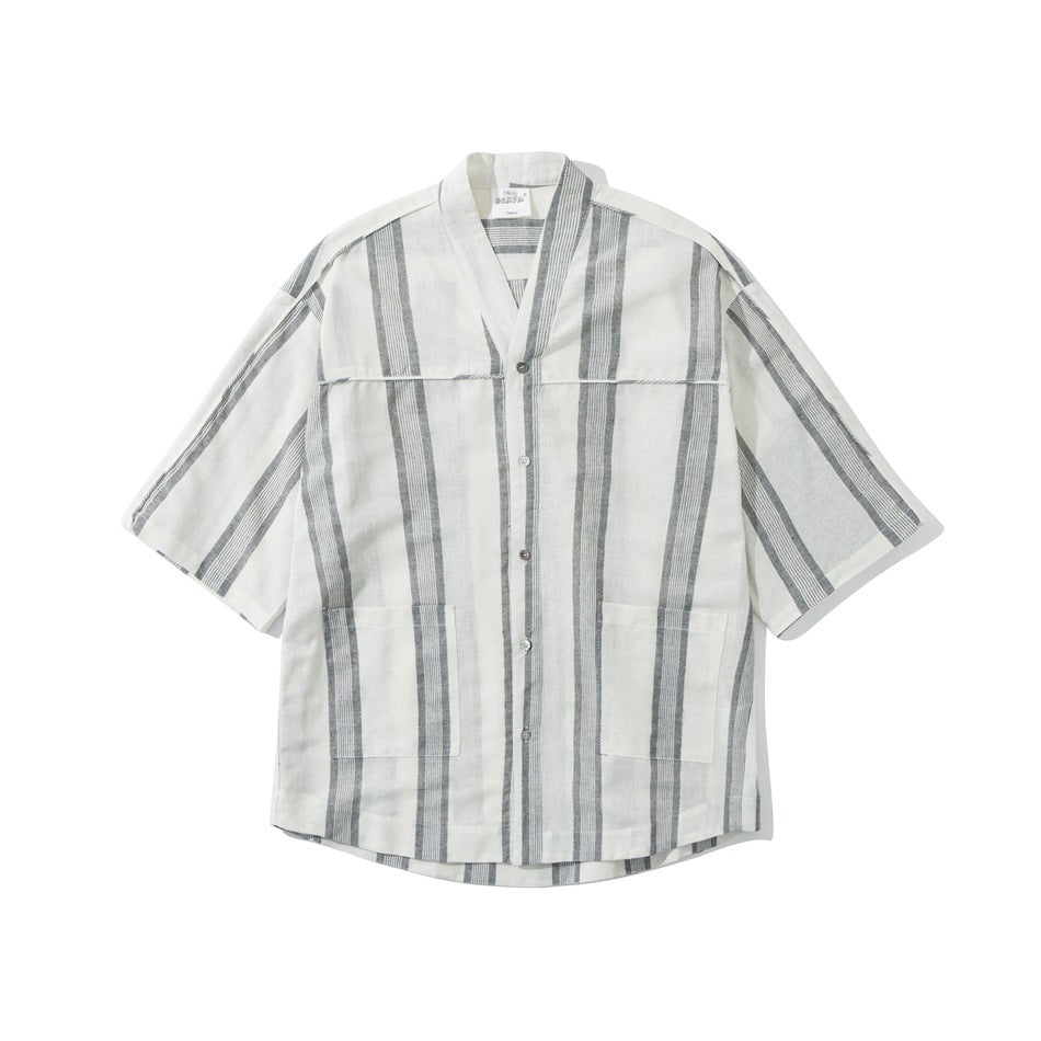 White short-sleeve shirt with gray vertical stripes, V-neck, button front and two patch pockets, laid flat