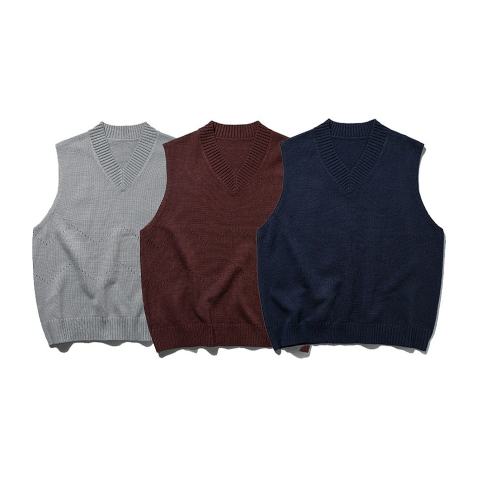 Three sleeveless V-neck sweater vests displayed from the front in light gray, burgundy, and navy.