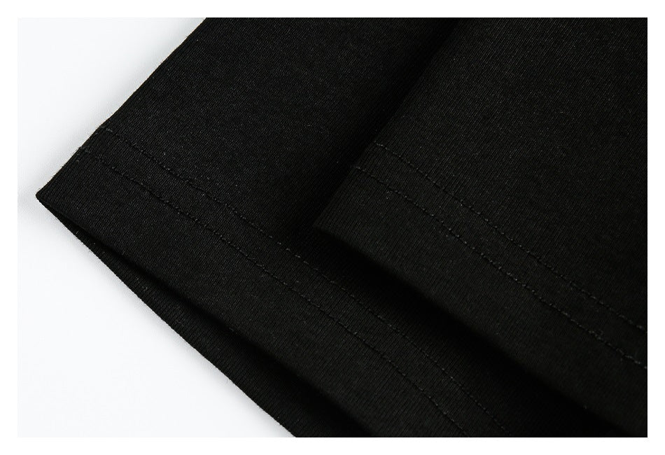 Close-up of the black top's sleeve hem with parallel rows of stitching.