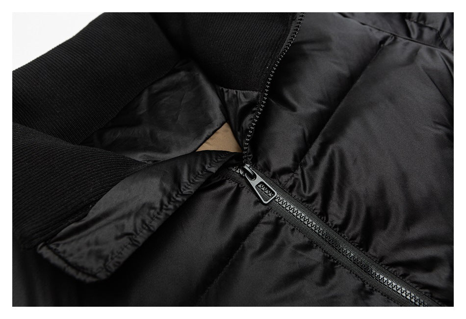 Close-up of a black zipper beside ribbed knit trim on a padded garment.