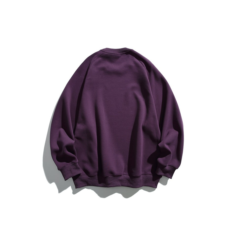 Back view of a solid deep purple raglan crewneck sweatshirt with ribbed cuffs and hem.