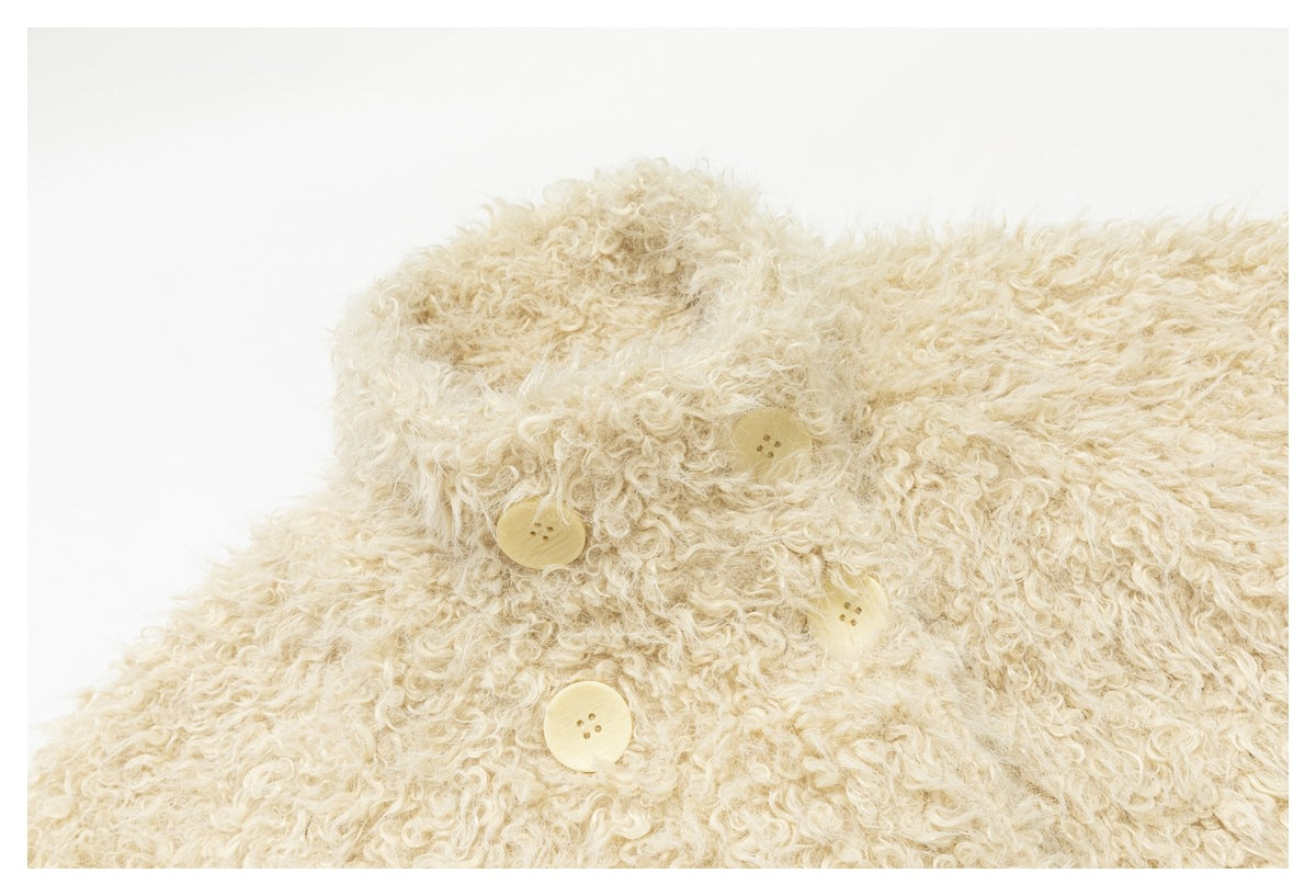 Close-up of the cream jacket’s collar and pale front buttons.